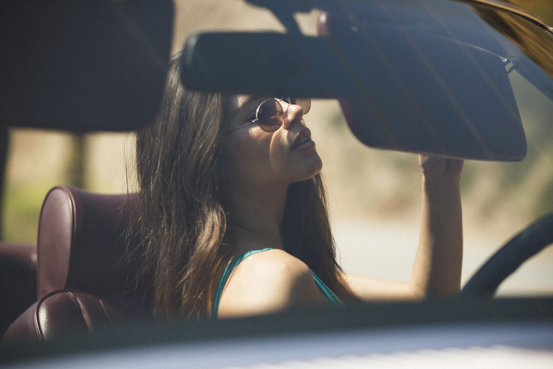 Girl in car with sunglasses